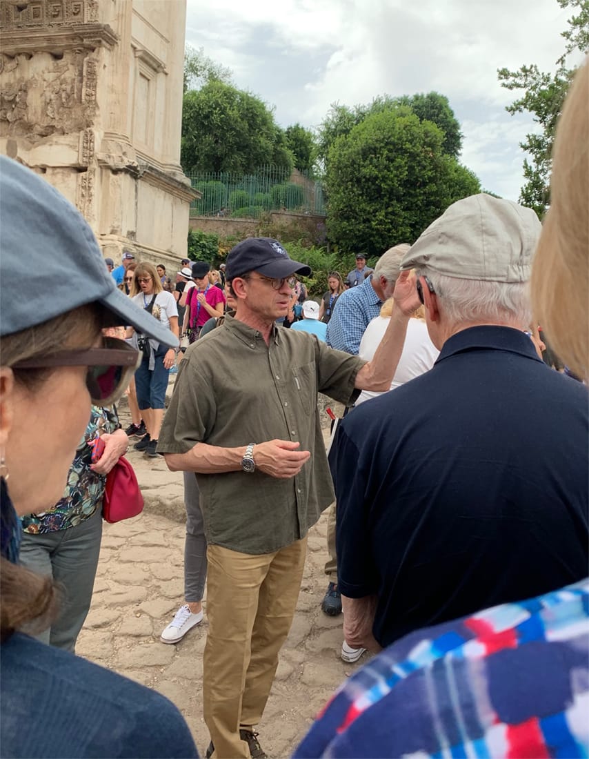2022 Alumni Fellow election candidate Daniel Weiss (in Yale baseball cap) speaking at the Roman Forum.